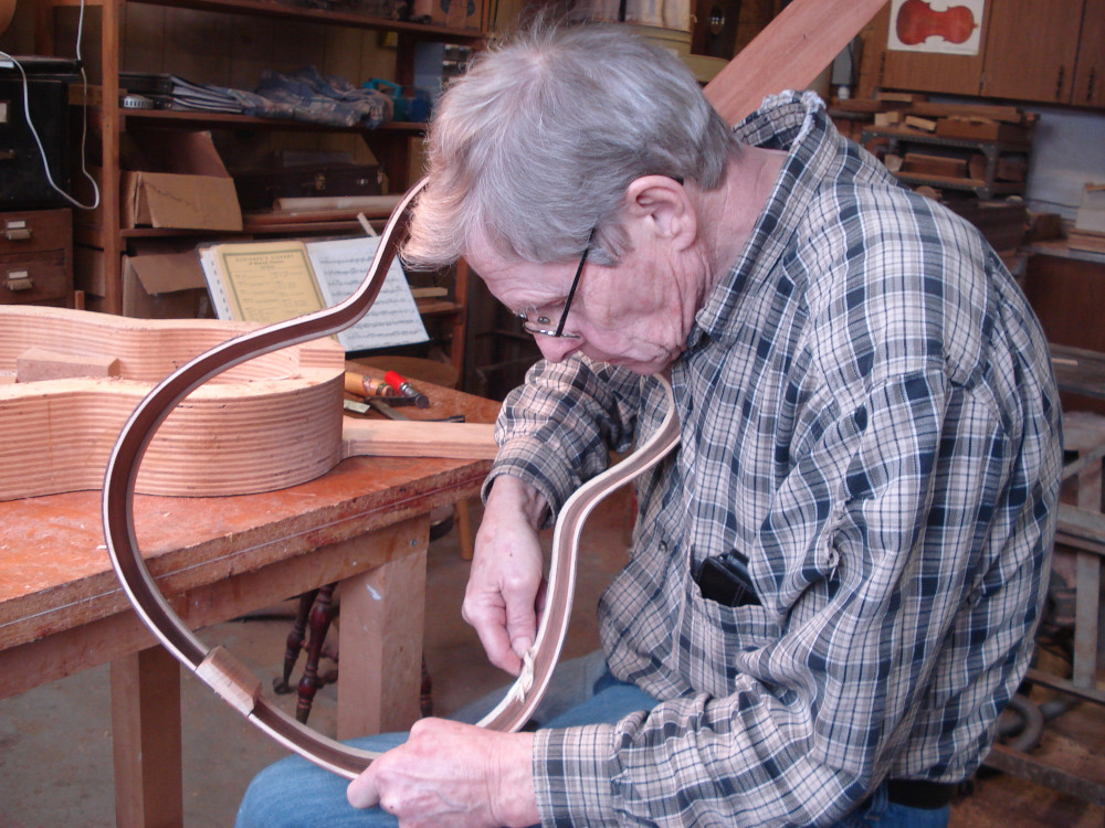 Bruce West working on a guitar